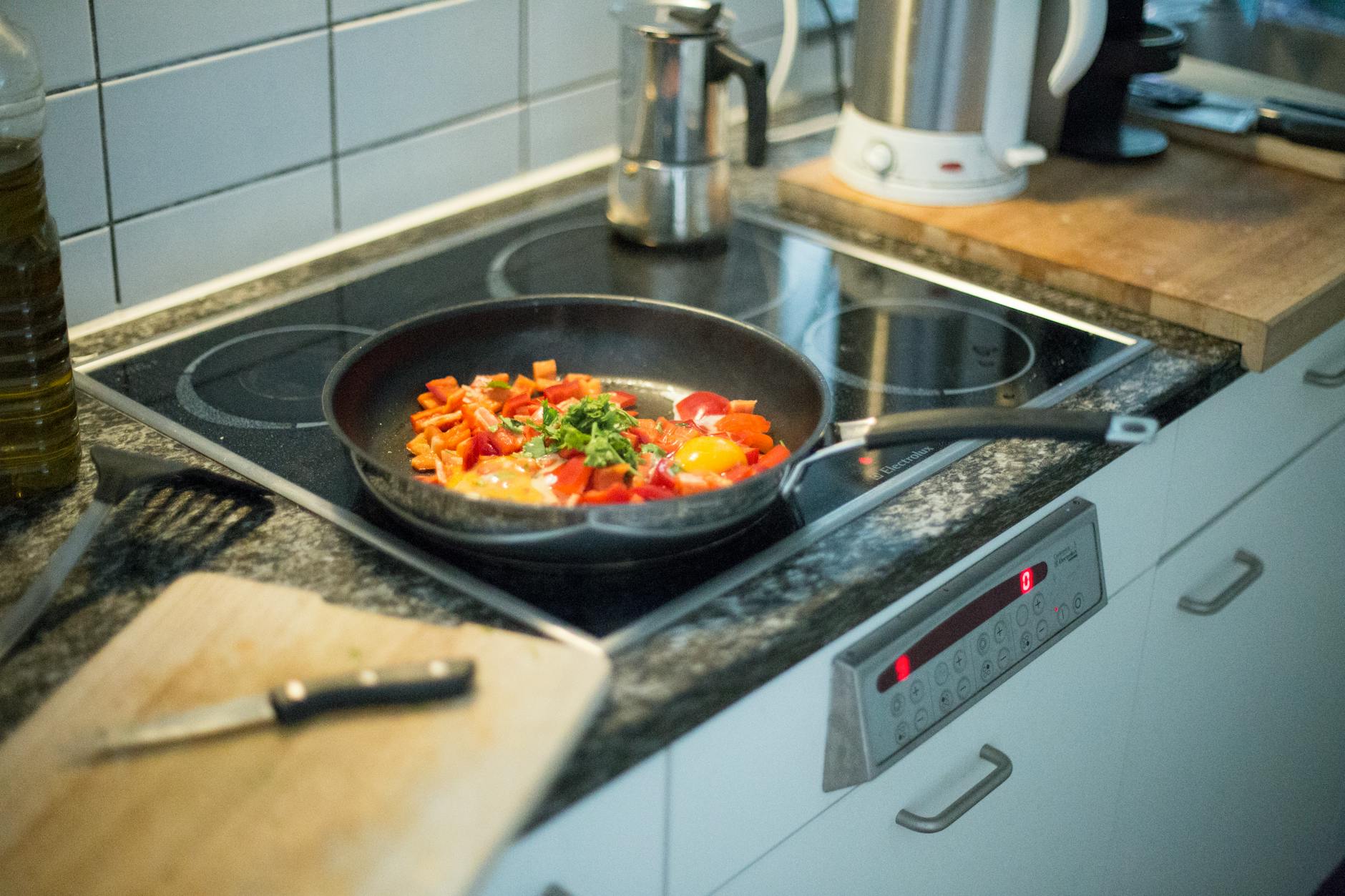 green and orange vegetables on black frying pan