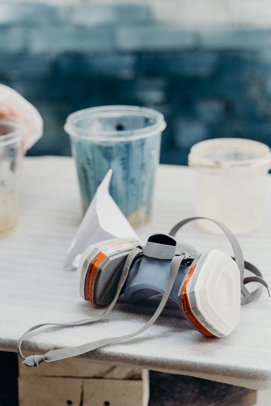 black and gray corded headphones on white table
