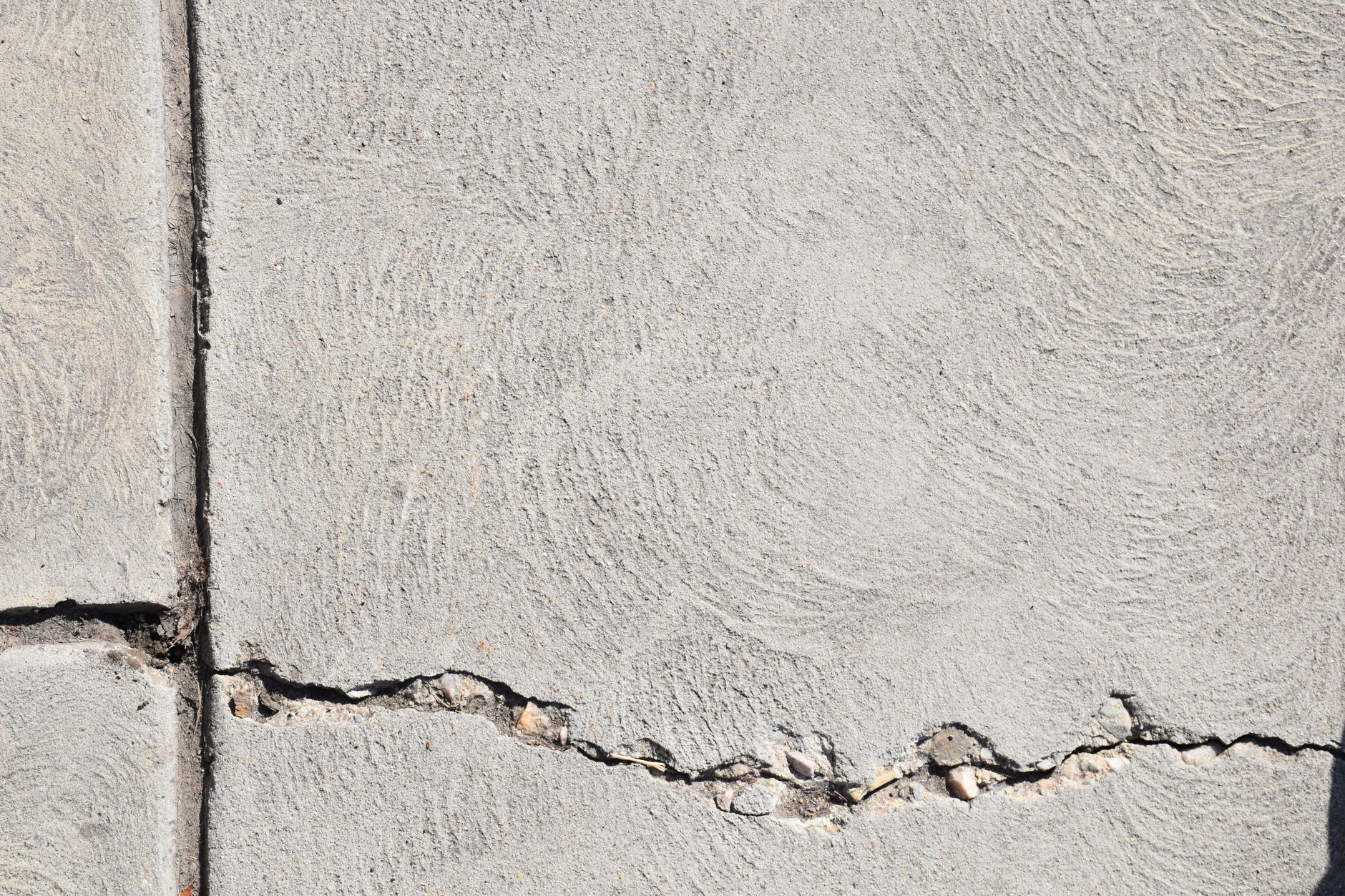 cracked concrete wall in close up photography